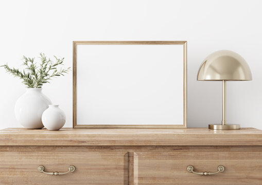 Horizontal wooden frame mockup in traditional living room interior with classic chest of drawers, brass lamp and olive twigs in vase on white wall background. Illustration, 3d rendering