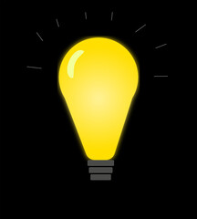 Image of a switched on light bulb in the dark on a black background