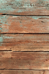Background from shabby boards with the remnants of blue and red paint