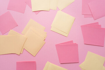 top view of empty paper notes on pink.