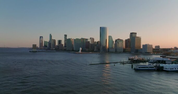 Aerial  view of tall  buildings on Hudson river sunset waterfront  piers  Jersey City, USA 2022