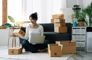 Portrait of Starting small businesses SME owners female entrepreneurs working on receipt box and check online orders to prepare to pack the boxes, sell to customers, SME business ideas online