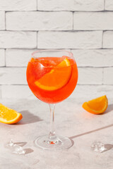 Glass of cold Aperol spritz cocktail.