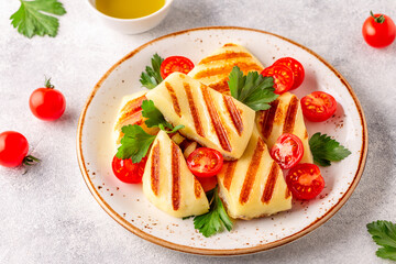 Grilled halloumi cheese served with tomatoes and parsley
