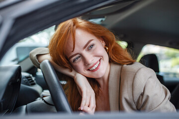 Young Woman Embracing Her New Car. Excited young woman and her new car indoors. Young and cheerful...