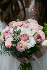 Wedding bouquet, close-up. Beautiful wedding couple. Happy bride and luxurious husband.