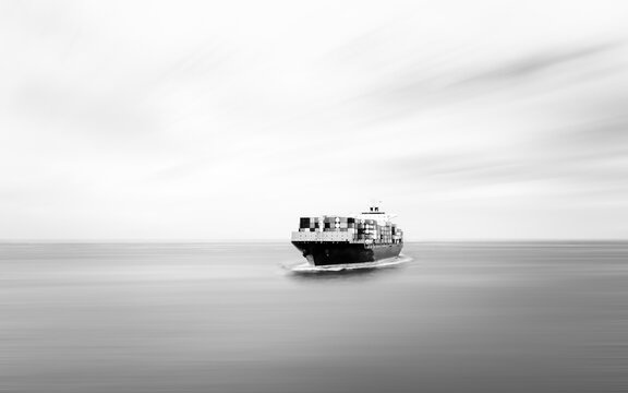 black and white Container ship sailing in deep sea for transporting cargo logistic import and export goods internationally around the world, including Asia Pacific and Europe, business and industry 