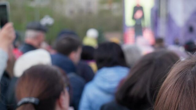A crowd of people at a street music concert defocusing, selective focus