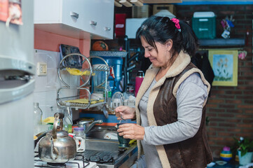 adult woman in home kitchen preparing tea