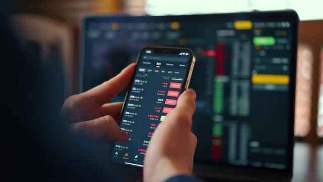 Businessman checking bitcoin price chart on digital exchange on mobile phone screen, cryptocurrency future price prediction concept