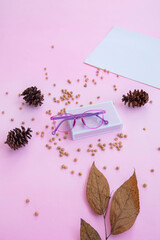 Fashion and beauty concept lying flat with oval glasses, women's accessories on pink background. Product Presentation of Minimalist Concept Ideas