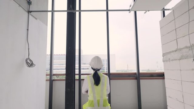 4k resolution slow motion, Young Asian woman engineer or Architect in construction site work.