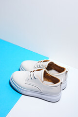 Trendy leather female sneakers. White milky color,