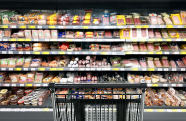 choosing a dairy products at supermarket.empty grocery cart in an empty supermarket