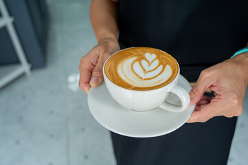 hot latte art coffee on hand table, relax time