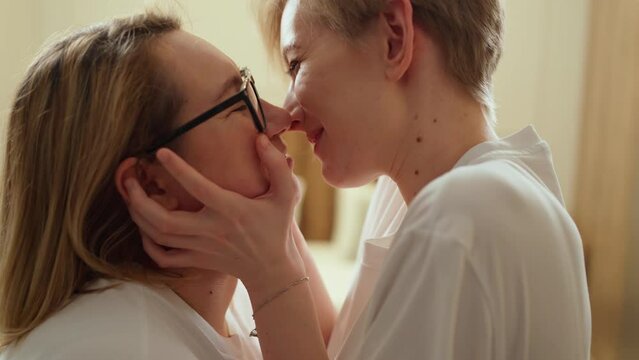 two young beautiful lgbt women hugging and kissing close up. tenderness, love
