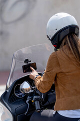 Woman manipulating GPS phone on motorcycle