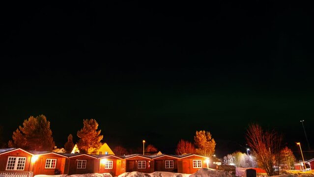 Alta, Norway. Watching Northern lights in the northern town of Alta, Norway. This is an iconic town for Aurora borealis tourism. Time-lapse with small houses