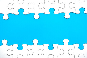White jigsaw puzzle with copy space for your business or connection message on blue background.    ...
