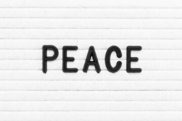 Black color letter in word peace on white felt board background