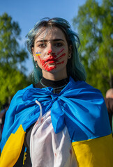 Protest against the war in Ukraine and Russian invasion. Portrait of a woman with Ukrainian...