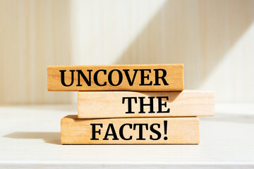 Wooden blocks with words 'Uncover the facts'.