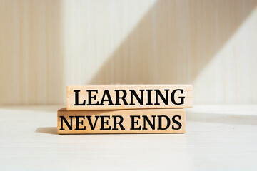 Learning Never Ends text concept written on wooden blocks lying on a table