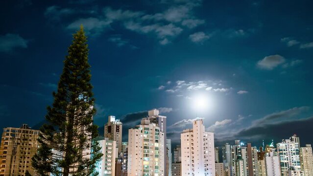 Timelapse image of night with full moon at Balneário Camboriú, Brazil.