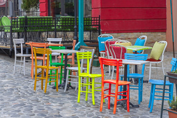 Fototapeta na wymiar Colourful Chairs Street Cafe
