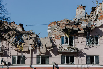 The ruins of the Hotel Ukraine against the blue sky in the city of Chernihiv during Russia's war...