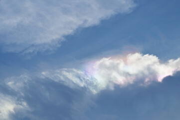 Iridescent Pileus Cloud is a beautiful natural phenomenon floating above The blue sky and white...