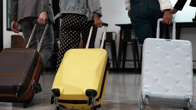 Close up Young people pulling suitcase and walk in airport. They carry luggage and passenger for tour travel booking ticket flight at international vacation time in holiday rest and relaxation.