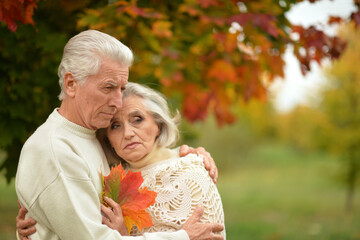 portrait of sad senior couple in the park