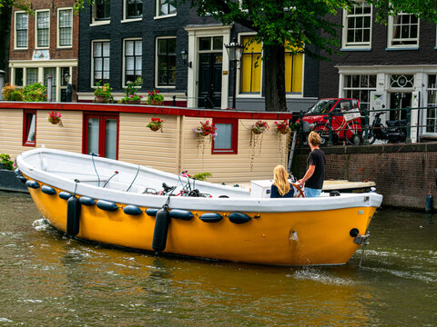 A couple in a boat in Amsterdam canals