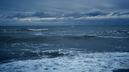 Fototapeta na wymiar Stormy sea landscape splashing on beach horizon line background. Nature concept.