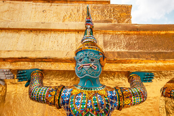 Close up giant statue at the base of Gold pagoda in Wat Phra Kaew (Temple of Emerald Buddha) in...