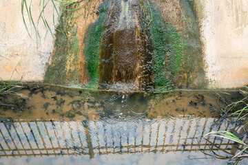 Industrial sewage water draining out into the public canal. Industrial pollution and environmental problem photo.