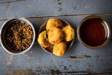 Aloo Batata Vada is Popular Mumbai food, Maharastrian Street food eaten with rassa and sprouted...