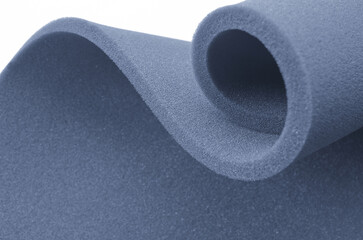 dark blue foam rolled up in a spiral isolated on a white background