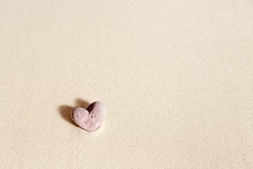 Fototapete Sea stone form heart pale pink colored on natural fine sand background. Natural pebble, monochrome tones. Spa minimal background, concept for meditation and relax, love © yrabota
