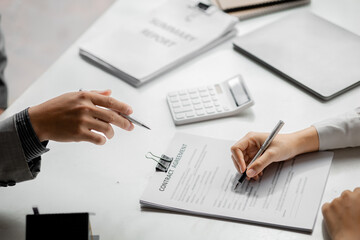 A rental company employee is calculating the cost for the customer to agree to sign a rental contract, explaining the rental terms and conditions. Home and real estate rental ideas.