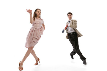 Young man and woman in vintage retro style outfits dancing social dance isolated on white...