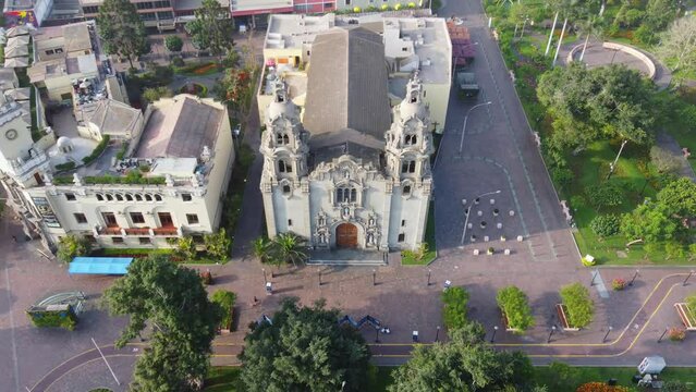 Drone video of church in Miraflores district of Lima Peru, near "Parque Kennedy" The shot is recorded while flying down and tilting camera up.