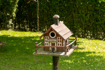 Obraz na płótnie Canvas Beautiful bird house on the way in the garden