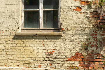 House facade vintage crumbling plaster and brick wall