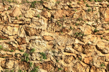 Old yellow brown masonry wall of stones