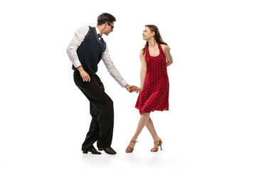 Beautiful girl and stylish man in vintage retro style outfits dancing isolated on white background. Timeless traditions, 60s,70s american fashion style and art