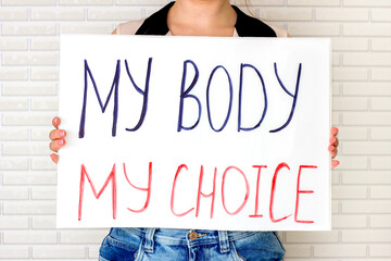 Woman holding a placard with My Body My Choice text. Reproductive women and pro-abortion rights protest concept. - 504202289