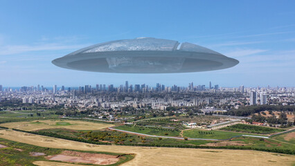 3d rendering,Massive ufo Flying saucer hovering over large city Aerial view
Drone view over tel...
