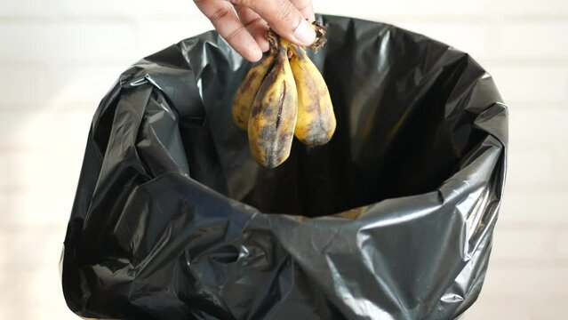 throwing banana in a garbage bin 